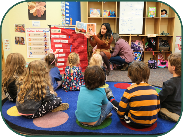 A teacher reads to a group of preschool students.